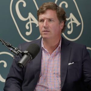 Tucker Carlson sits in front of a mic with the Culture Apothecary logo behind him.