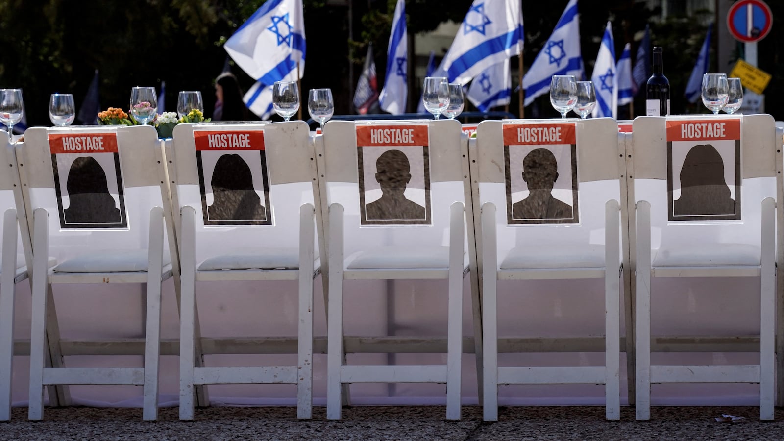 A dinner table is set with empty chairs that symbolically represent hostages and missing people with families that are waiting for them to come home, in Tel Aviv, Israel, Oct. 20, 2023.