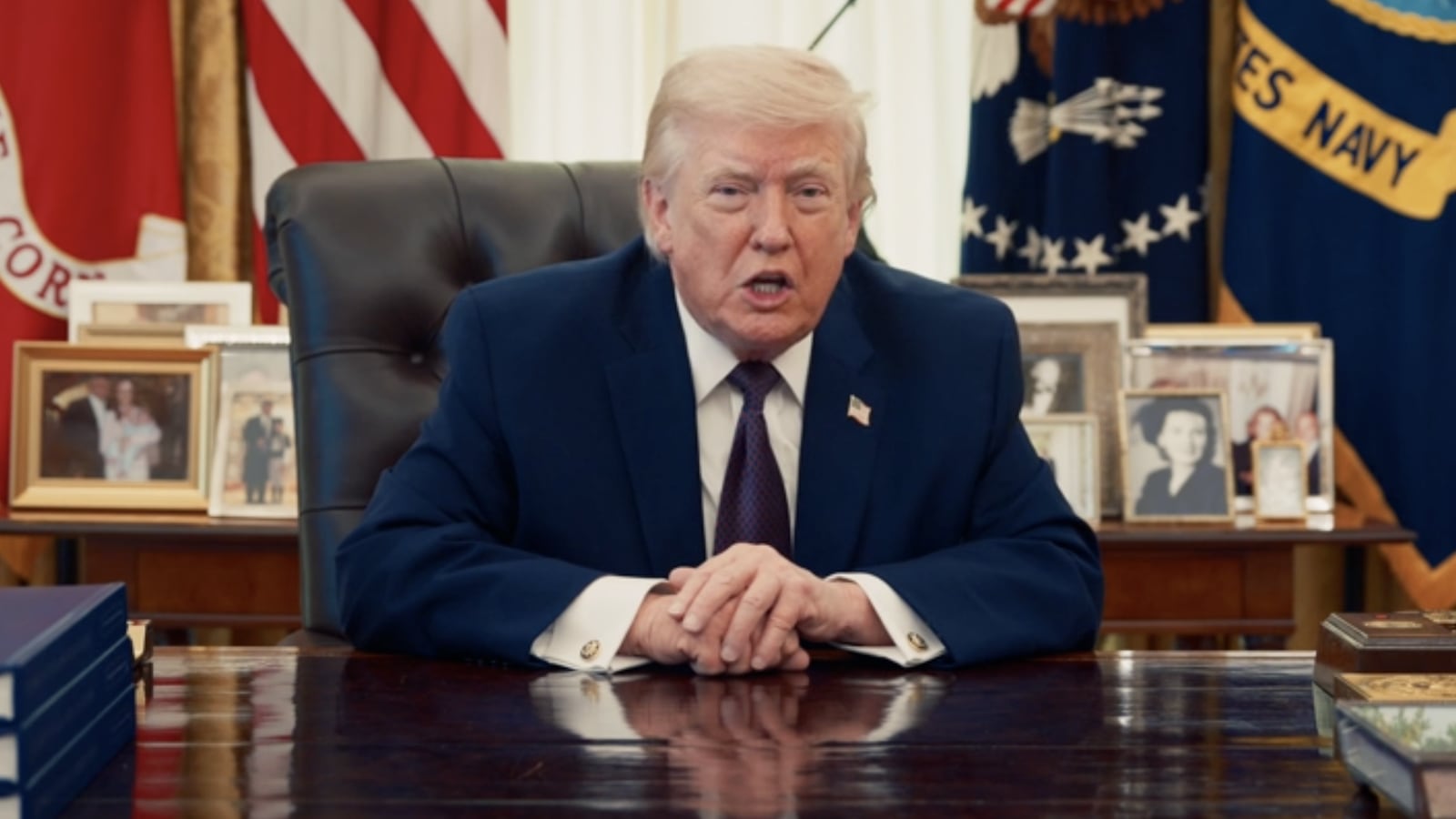 President Trump sits behind the Resolute Desk in a Truth Social video.