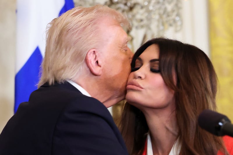 U.S. President Donald Trump kisses Kimberly Guilfoyle, during the Greek Independence Day celebration at the White House in Washington, D.C.,  March 24, 2025.