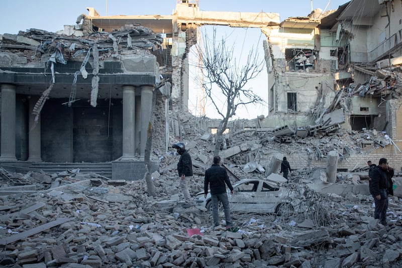 People inspect the site of an Israel and U.S. strike on a police station in Tehran, Iran, March 3, 2026.
