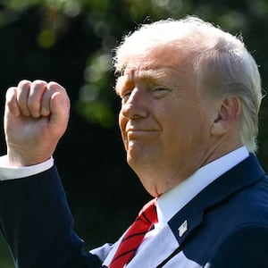 TOPSHOT - US President Donald Trump gestures as he walks to Marine One on the South Lawn of the White House in Washington, DC, on October 10, 2025, on his way to Walter Reed National Military Medical Center to receive a medical checkup. (Photo by SAUL LOEB / AFP) (Photo by SAUL LOEB/AFP via Getty Images)