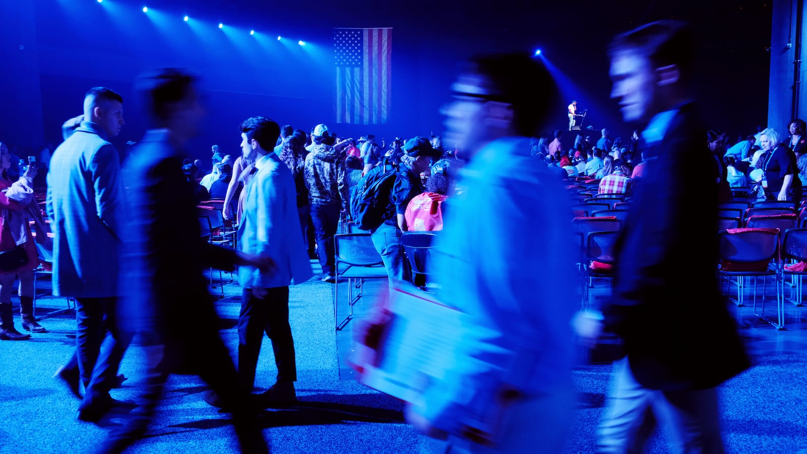 People attend Turning Point USA’s America Fest 2021, a gathering of conservative’s and Donald Trump supporters, on December 18, 2021 in Phoenix, Arizona with some of the conference's sponsors including the Young Americans for Liberty.