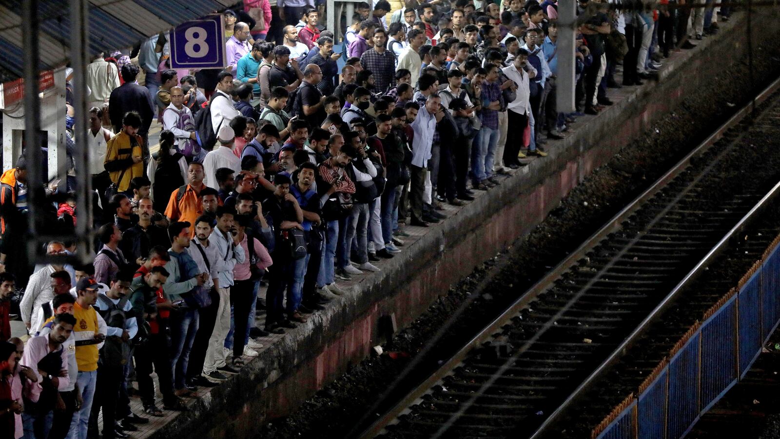 Commuters crowd on a platform as they wait to board suburban trains at a railway station in Mumbai, India, January 20, 2023.