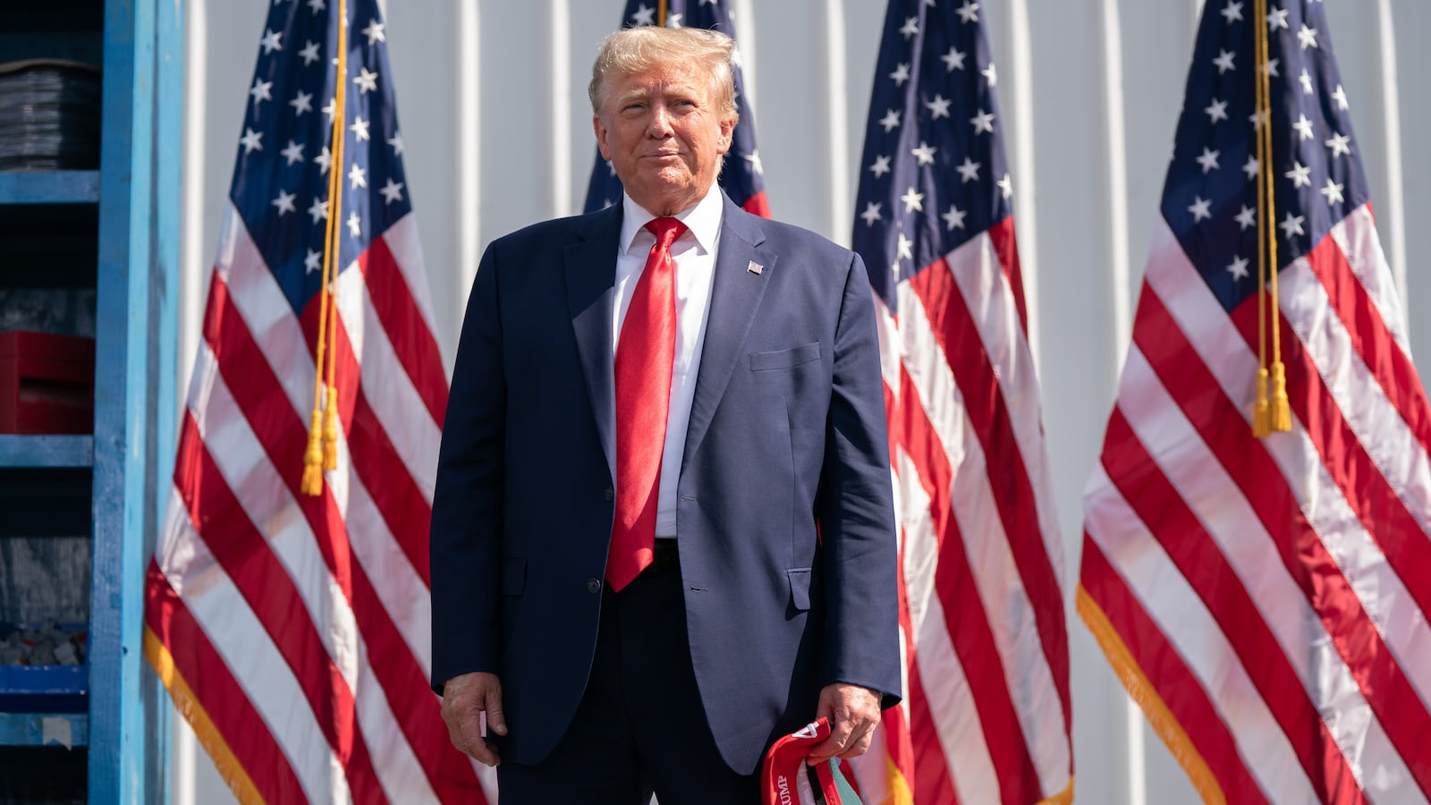 Donald Trump stands in front of American flags during a campaign rally on September 25, 2023 in Summerville, South Carolina.