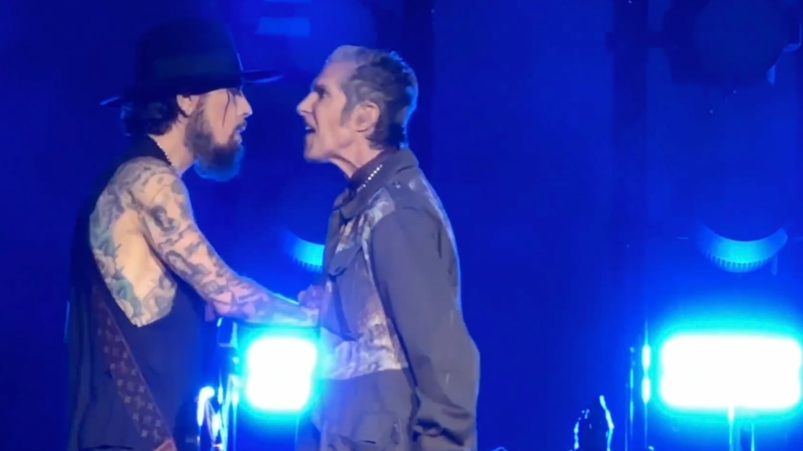Jane’s Addiction frontman Perry Farrell punches guitarist Dave Navarro at their Boston concert.