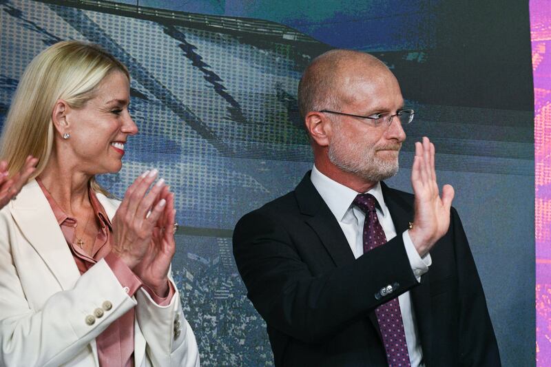 Attorney General Pam Bondi and Federal Communications Commission Chairman Brendan Carr look on as US President Donald Trump speaks during an event to sign an executive order on creating a White House 2028 Olympics task force in the South Court Auditorium of the White House in Washington, DC, on August 5, 2025.