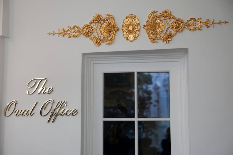 A new sign and gold ornamentation adorn the door of the Oval Office at the White House. REUTERS/Evelyn Hockstein.