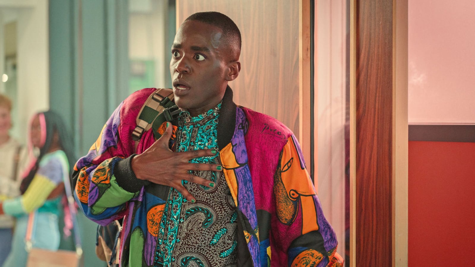 Ncuti Gatwa in ‘Sex Education’ with his hand on his chest in shock