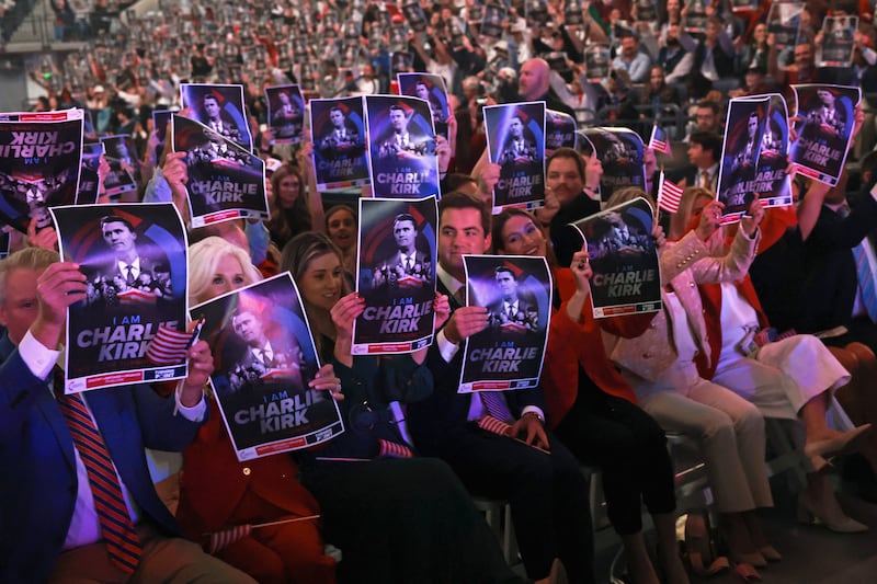 TOPSHOT - Attendees hold posters of late right-wing activist Charlie Kirk during a Turning Point USA event at the University of Mississippi, in Oxford, Mississippi, October 29, 2025. (Photo by JONATHAN ERNST / POOL / AFP) (Photo by JONATHAN ERNST/POOL/AFP via Getty Images)
