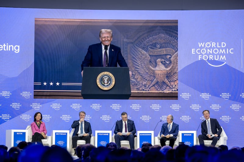 US President Donald Trump is seen on a giant screen during his address by video conference at the World Economic Forum (WEF) annual meeting in Davos on January 23, 2025. (Photo by FABRICE COFFRINI / AFP via Getty Images)
