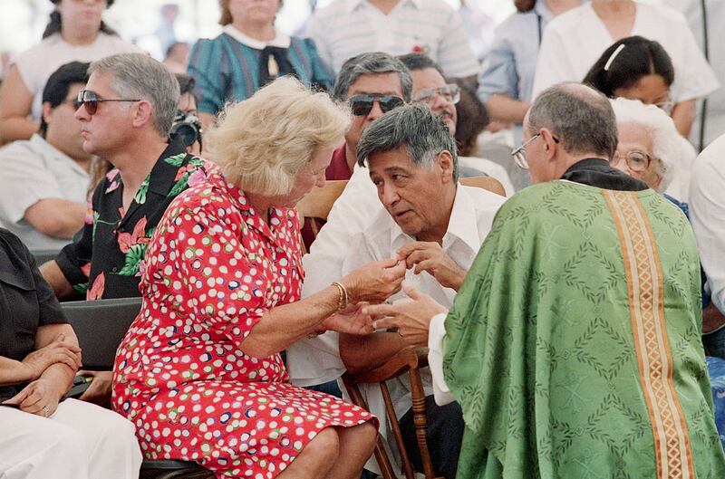 United Farm Workers (UFW) leader, Cesar Chavez, receives a small piece of bread from Ethel Kennedy during a mass, ending his 36-day fast over the reckless use of deadly pesticides, Delano, California, 21st August 1988. At far right is UFW Chaplain, Father Ken Irrgang.
