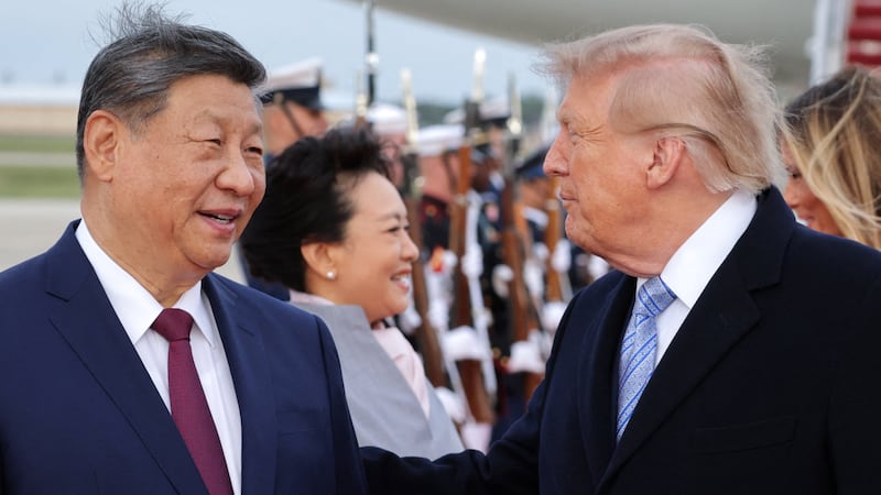 Donald Trump and Chinese President Xi Jinping speak as Xi arrives ahead of a state visit at Joint Base Andrews, Maryland.