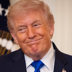 President Donald Trump listens as Laura Wilkerson speaks during the Angel Families Remembrance Ceremony in the East Room of the White House in Washington, DC on February 23, 2026.