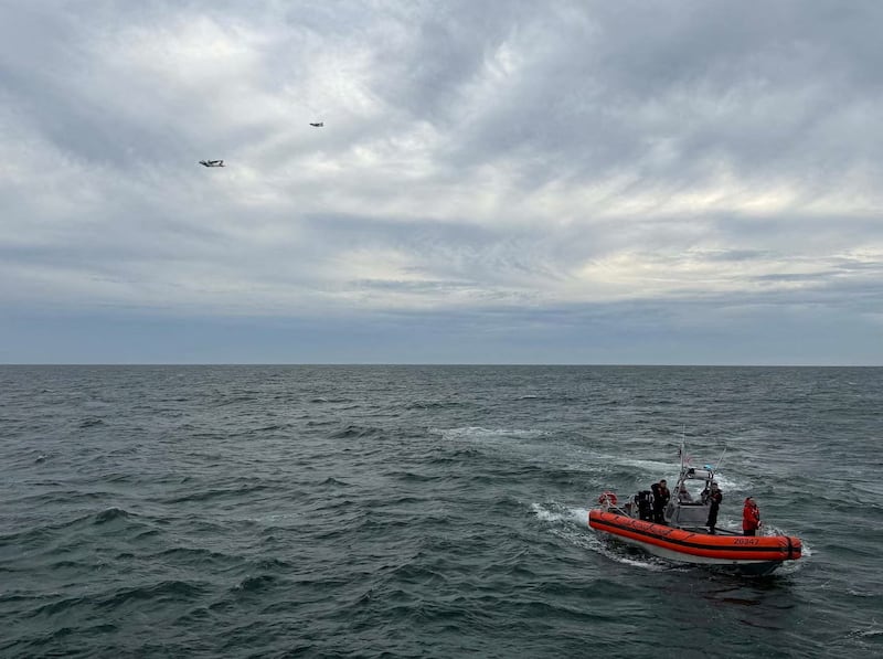 U.S. Coast Guard members search for people after it found debris from a medical transport aircraft off the shore of Massachusetts' Nantucket island, October 3, 2026.