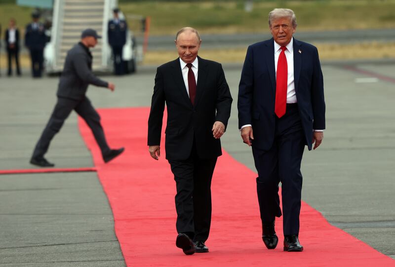 ANCHORAGE, ALASKA - AUGUST 15: (RUSSIA OUT) U.S. President Donald Trump welcomes Russian President Vladimir Putin to Joint Base Elmendorf-Richardson on August 15, 2025 in Anchorage, Alaska. The two leaders are meeting for peace talks aimed at ending the war in Ukraine. (Photo by Contributor/Getty Images)