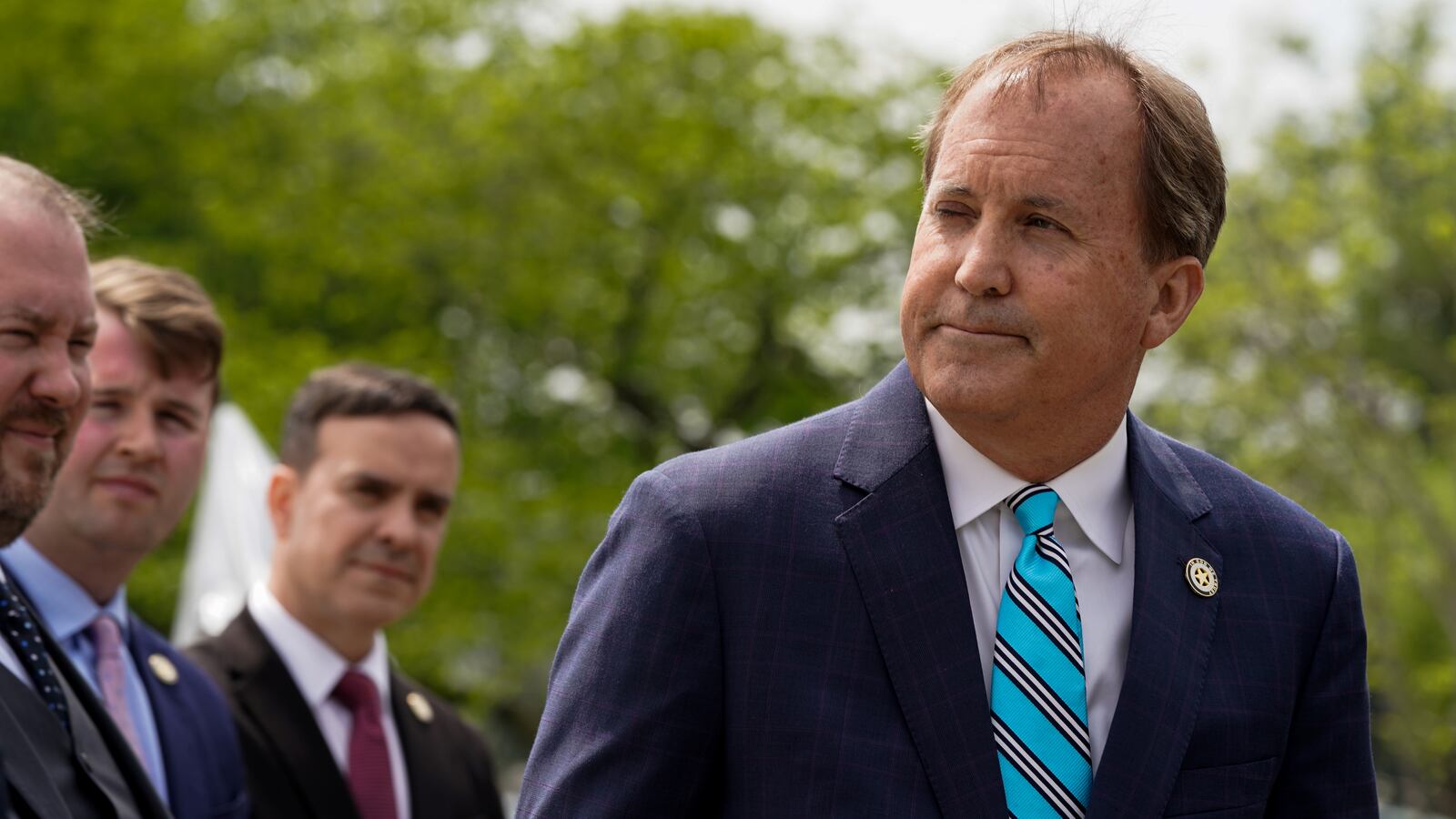 Ken Paxton pauses and stares right during a 2022 press conference.