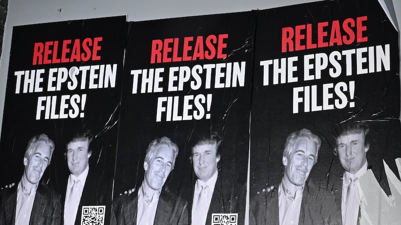 A poster with an image of Donald Trump and Jeffrey Epstein is seen along Rhode Island Ave.