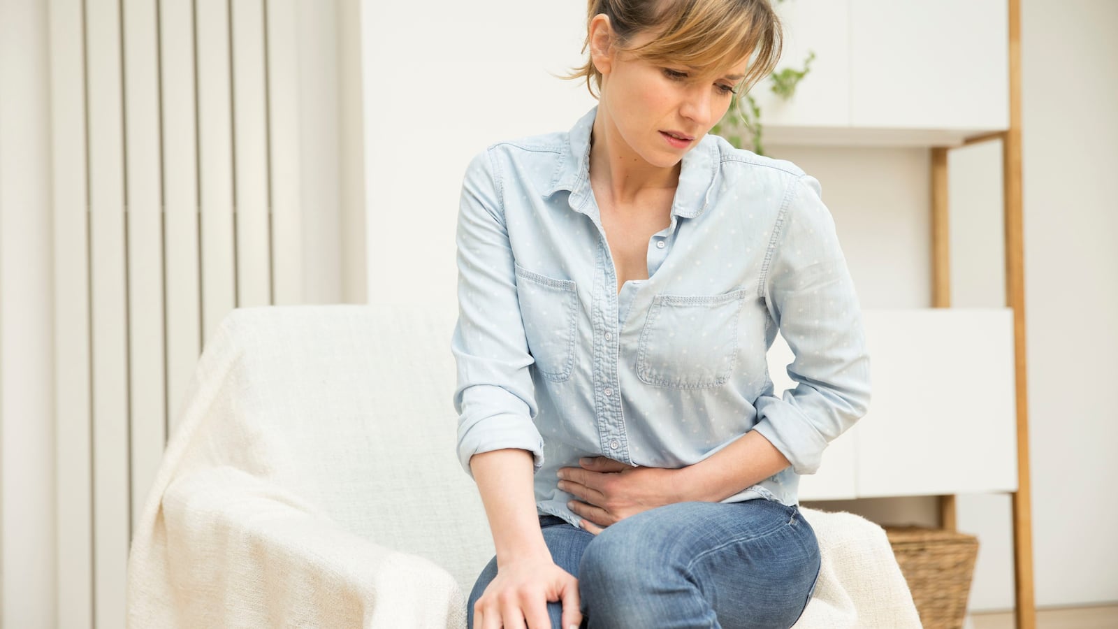 Woman suffering from abdominal pain.