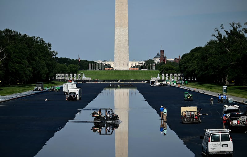 Contractors drive a vehicle in the partially filled Lincoln Memorial Reflecting Pool during renovation work at the National Mall in Washington, DC, on June 4, 2026.