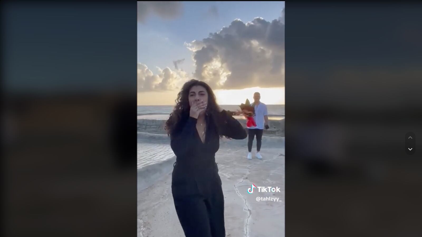 Adam Rizk holding a bouquet of flowers for Vanessa Moujalli.