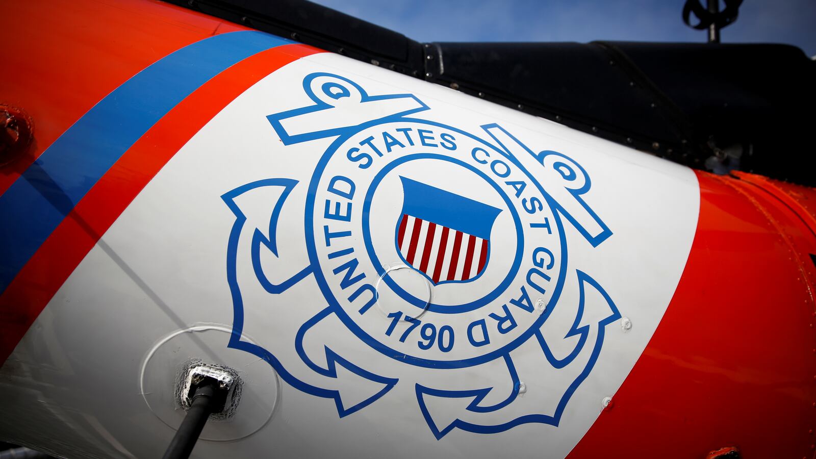 U.S. Coast Guard's logo is seen on a helicopter on the deck