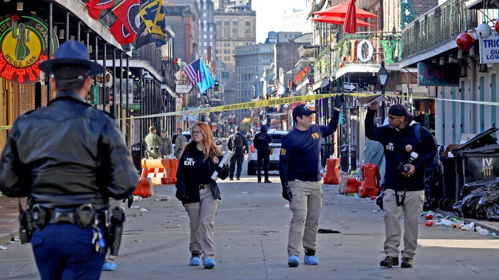 Police descend on Bourbon Street after more than a dozen people were killed when a person drove into a crowd of revelers in the early morning hours of New Year's Day.