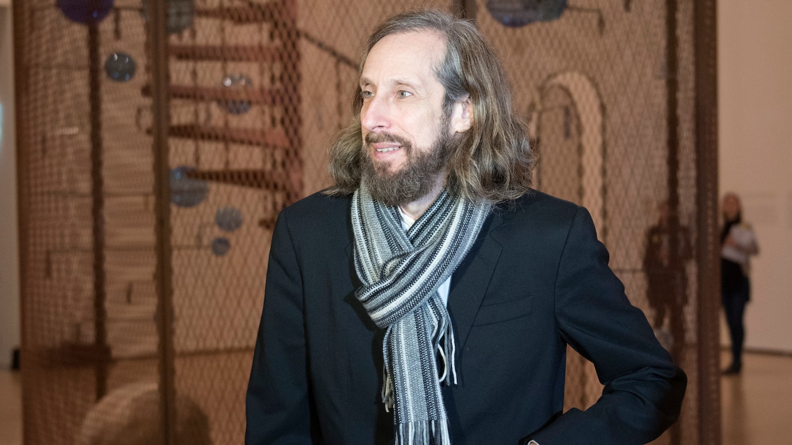 Jerry Gorovoy, the assistant of French artist Louise Bourgeois, poses next to an artwork.