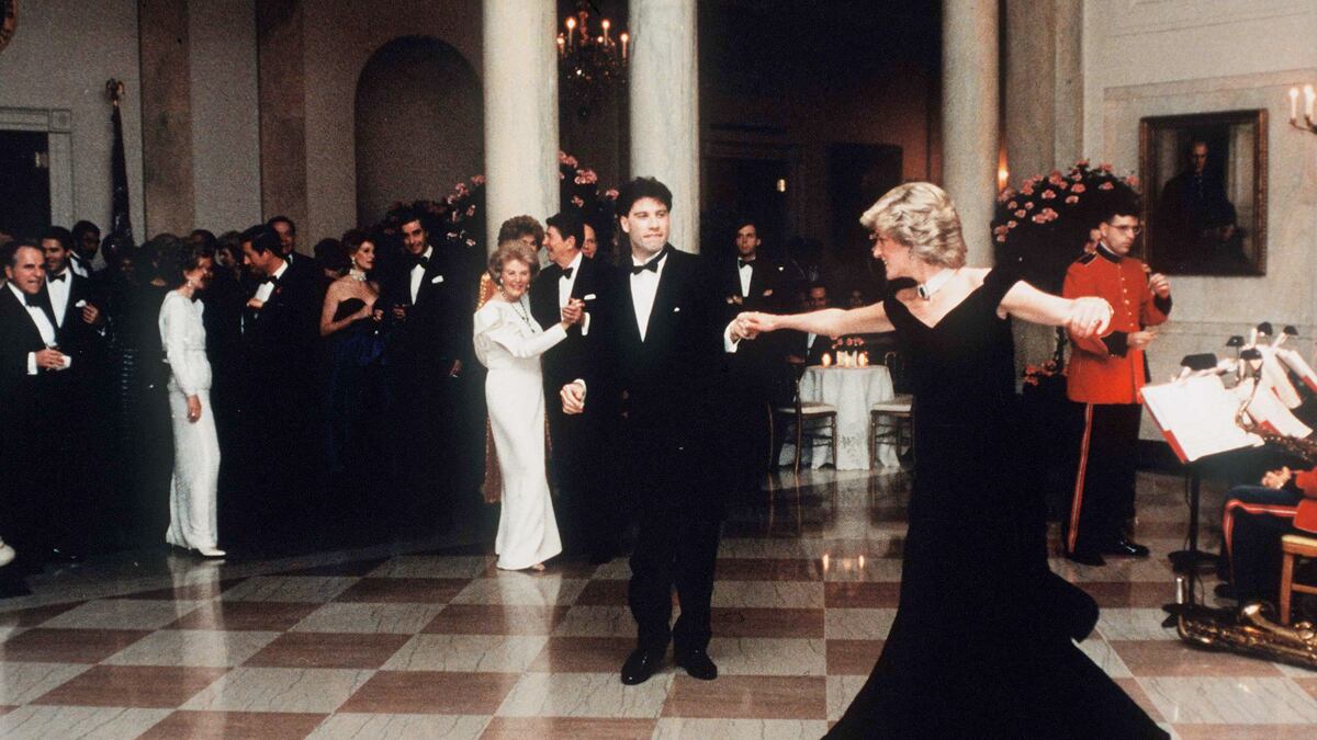 articles/2013/03/20/princess-diana-s-fabulous-dresses-sell-for-1-2m/diana-travolta_tgojm2