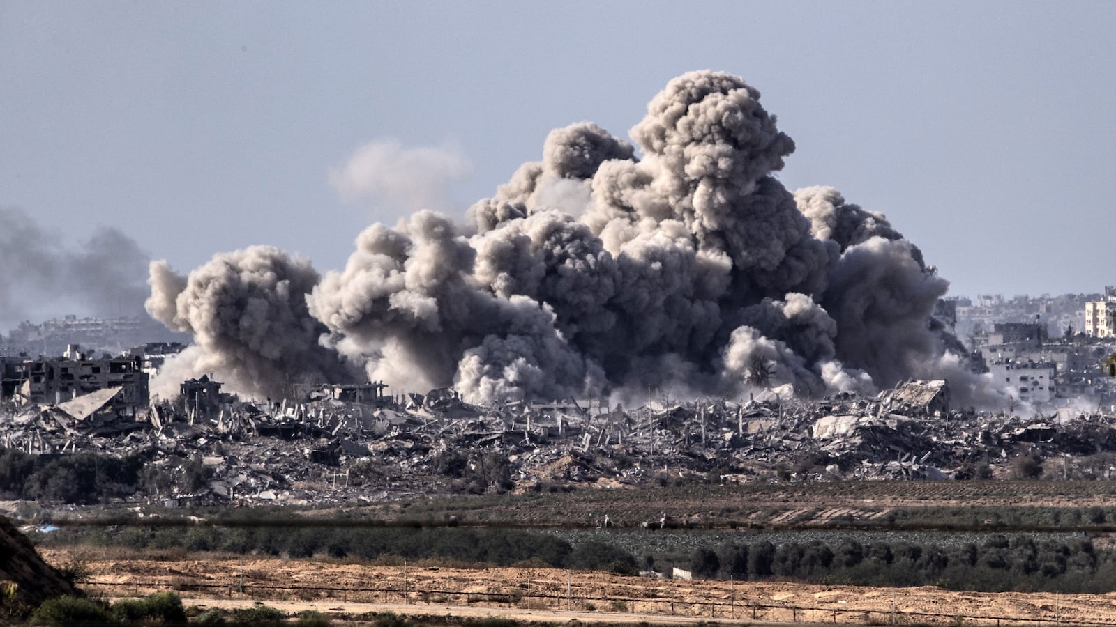 A picture of smoke rising over destroyed buildings in Gaza
