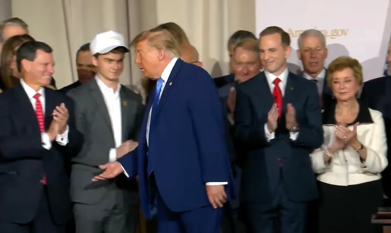 Donald Trump walks past Edward 'Big Balls' Coristine.