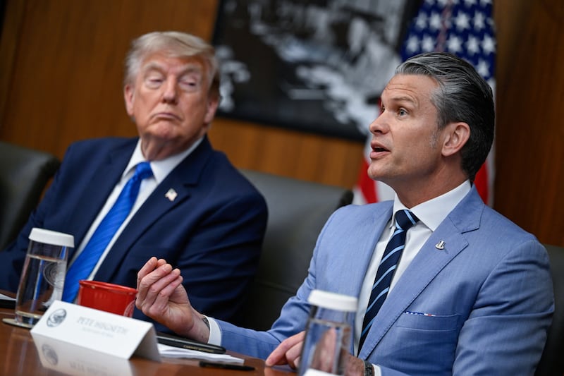 U.S. President Donald Trump listens as Secretary of Defense Pete Hegseth speaks during a cabinet meeting at Camp David in Thurmont, Maryland, U.S., July 31, 2026.