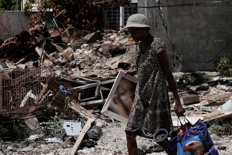 A resident returns to the Route de Nazon neighborhood after gang leader Jimmy "Barbeque" Cherizier withdrew his soldiers from several neighborhoods in northeastern Port-au-Prince and urged former residents to return to their homes, in Port-au-Prince, Haiti August 28, 2025. REUTERS/Jean Feguens Regala