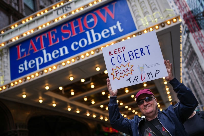 Richie Vitale, 71, holds a sign outside of the Ed Sullivan Theater before the taping of the final episode of the "The Late Show" with Stephen Colbert, in New York City, U.S., May 21, 2026.