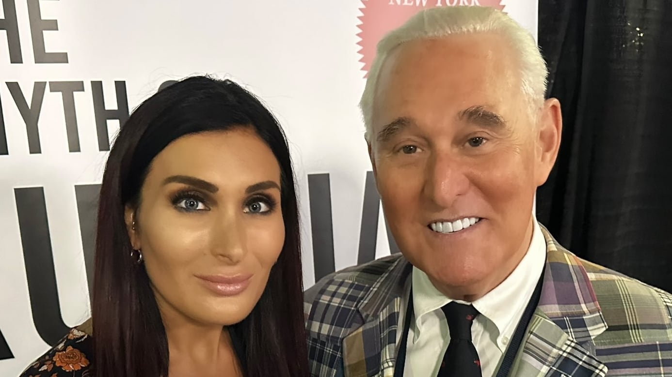 Laura Loomer and Roger Stone pose for a photo together.