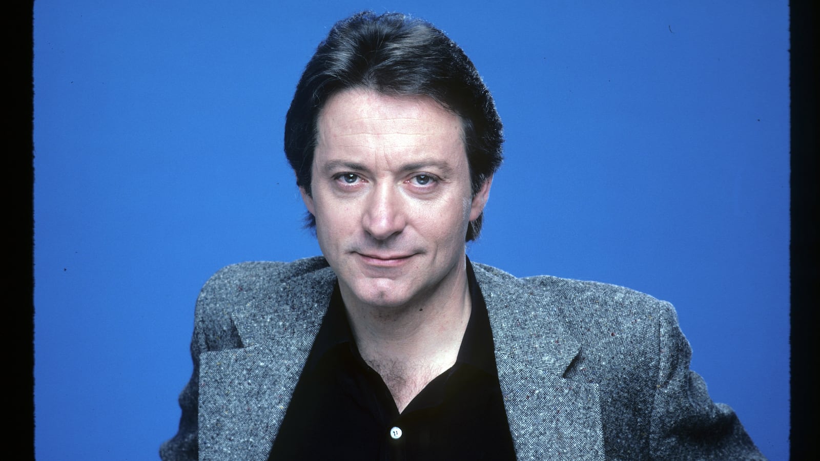 A portrait of Star Trek actor James Sloyan against a blue background.