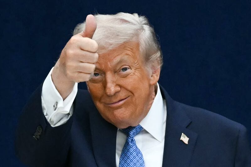 President Donald Trump gives a thumbs up as he departs the stage during the signing ceremony on December 4, 2025.