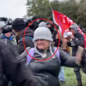 A screengrab of Dana Jean Bell kicking an unseen journalist in front of the Capitol on January 6, 2021.