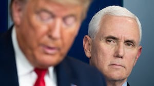 Mike Pence listens as Donald Trump speaks during a press briefing at the White House in Washington, DC, on March 26, 2020.