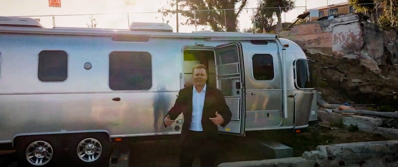 Spencer Pratt emerging from a trailer.