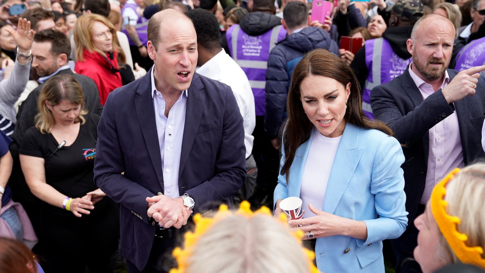 The Prince and Princess of Wales speak with the public during an event.