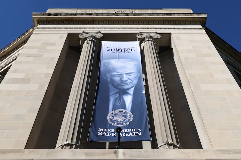 A banner of U.S. President Donald Trump hangs from the U.S. Department of Justice in Washington, D.C., April 6, 2026. REUTERS/Kevin Lamarque