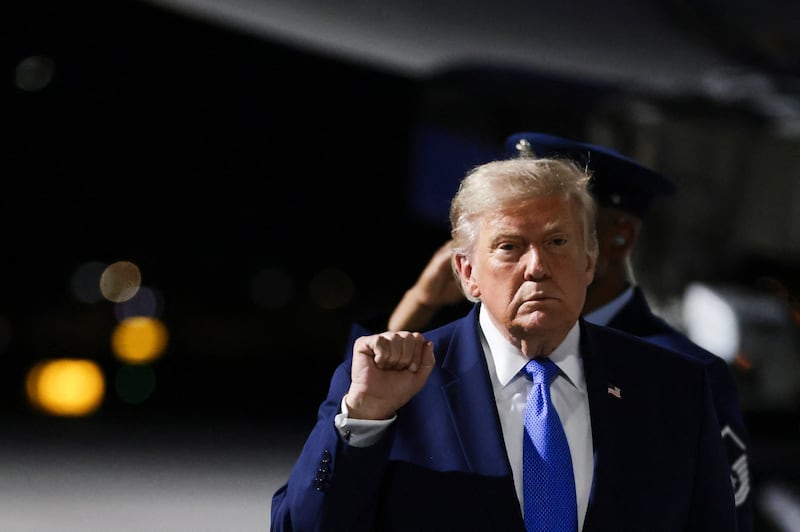 U.S. President Donald Trump gestures as he walks after deboarding Air Force One upon arrival at Harry Reid International Airport in Las Vegas, Nevada, U.S., August 4, 2026.