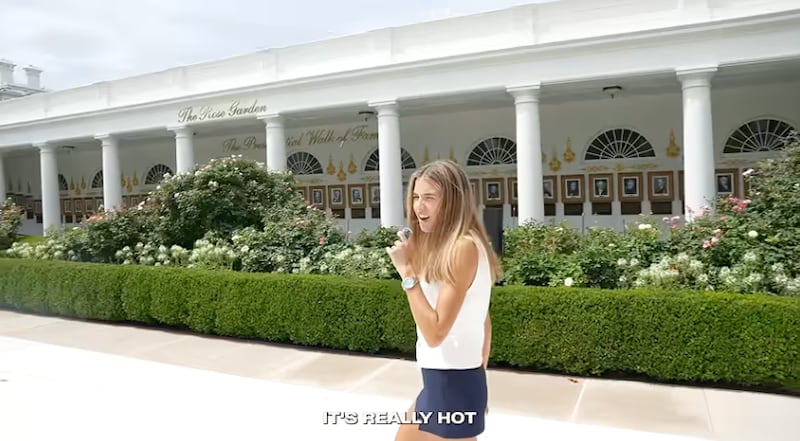 Kai Trump squints on the paved Rose Garden lawn.