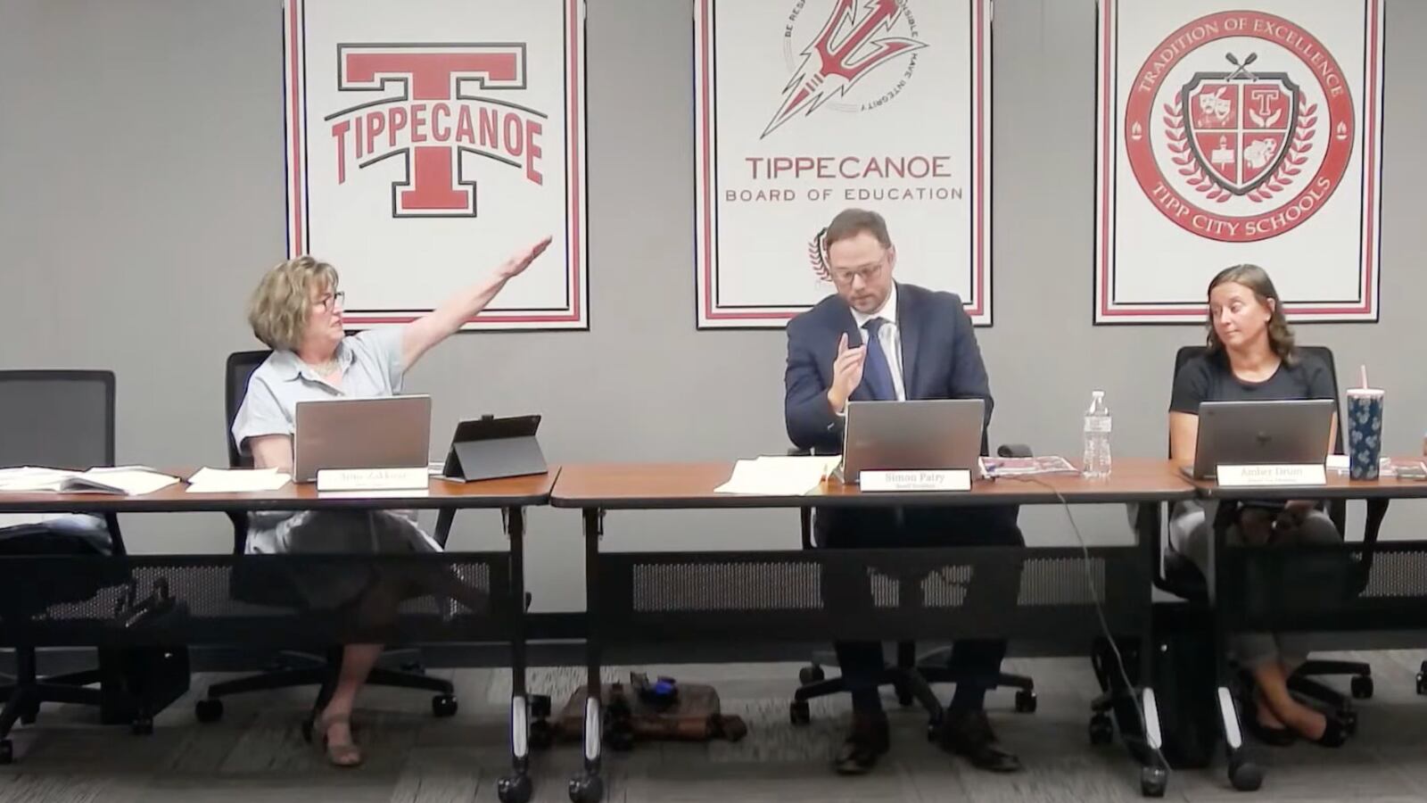 Tipp City School Board member Anne Zakkour gives a Nazi salute to president Simon Patry.