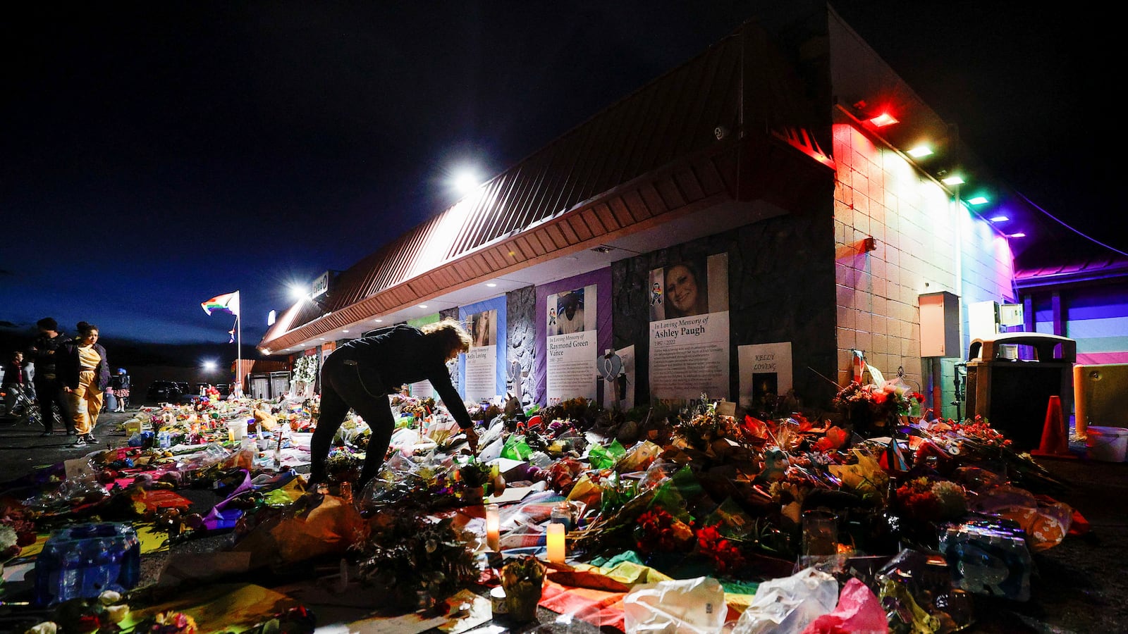 A person lights a candle left at the memorial in front of Club Q after a mass shooting at the LGBTQ nightclub, in Colorado Springs, Colorado, U.S. November 26, 2022.