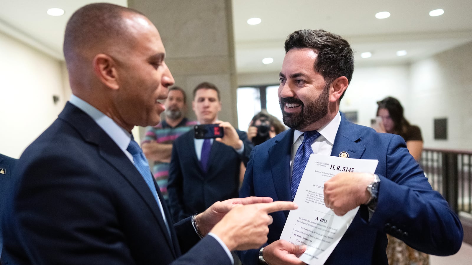 Rep. Mike Lawler, R-N.Y., right, confronts House Minority Leader Hakeem Jeffries, D-N.Y., about signing on to a bill that would extend Affordable Care Act tax credits, after a House Democrats news conference in the Capitol Visitor Center on on Oct. 8, 2025.