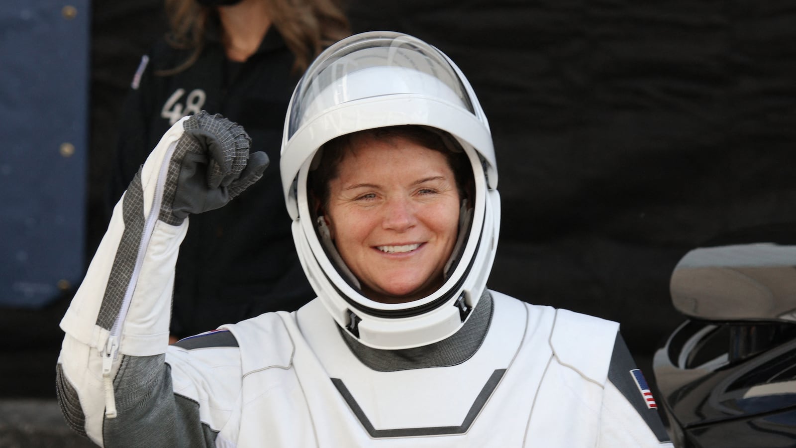 Crew-10 mission commander and NASA astronaut Anne McClain gestures before heading to the launch pad at the Kennedy Space Center