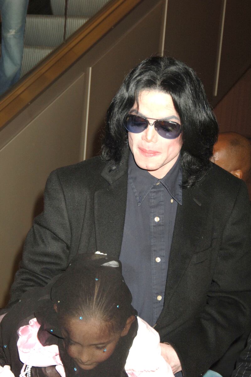 Michael Jackson walks with his daughter, Paris, as they visit Harrods October 12, 2005 in London, England.