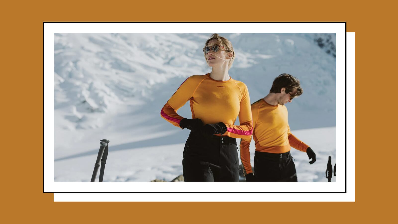 A woman and a man wearing thermals on a skiing slope.